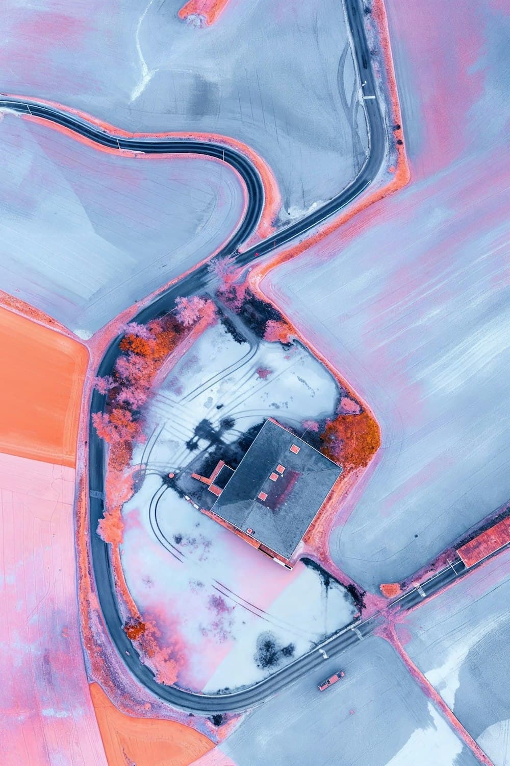 Aerial view of a winding road between fields